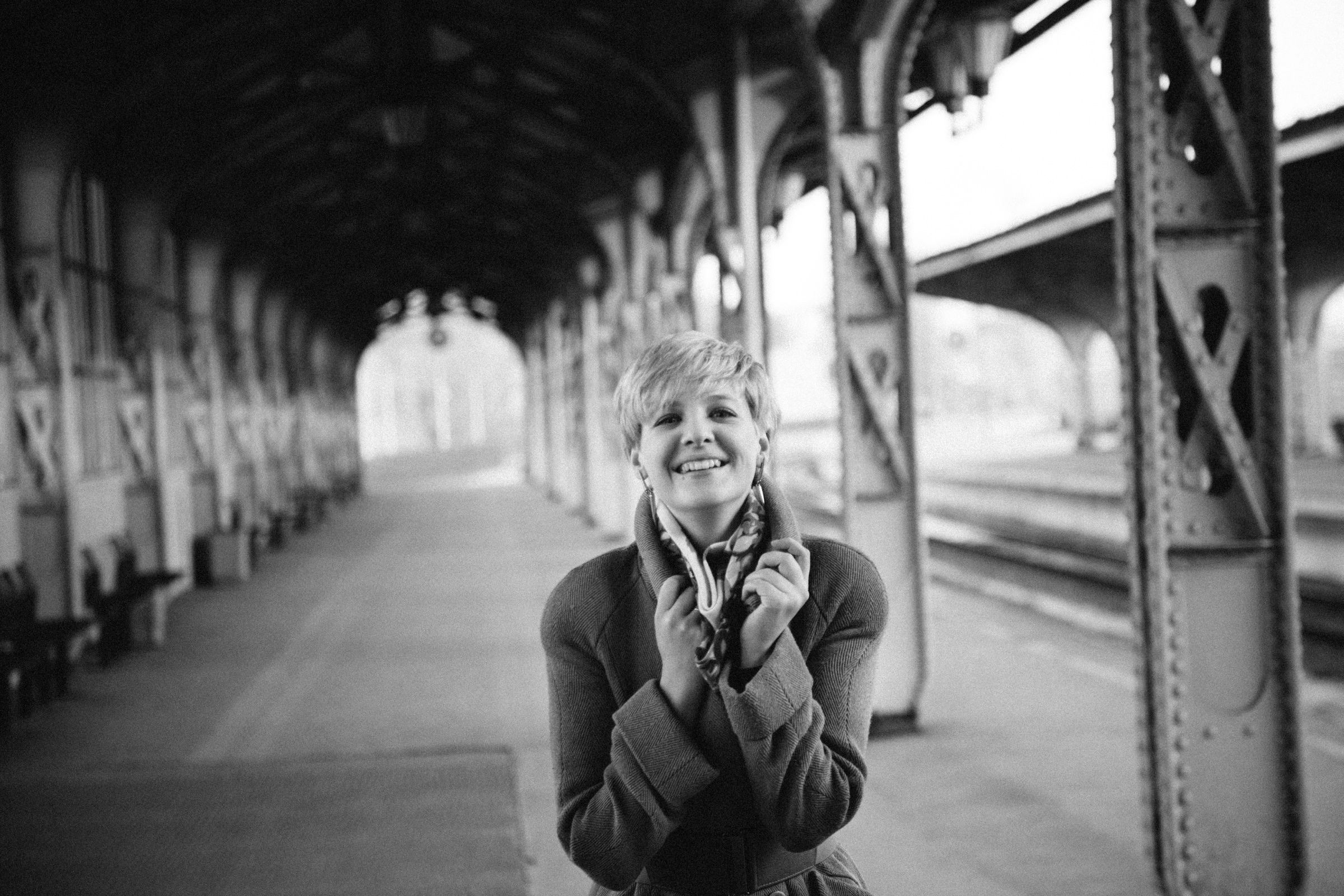 Black-and-white portrait of a young woman at a station